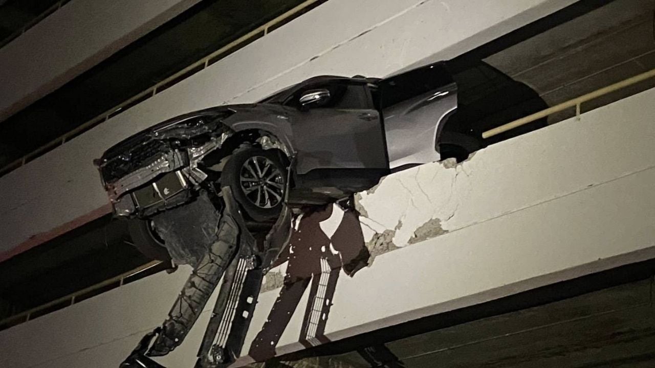SUV nearly falls off parking building