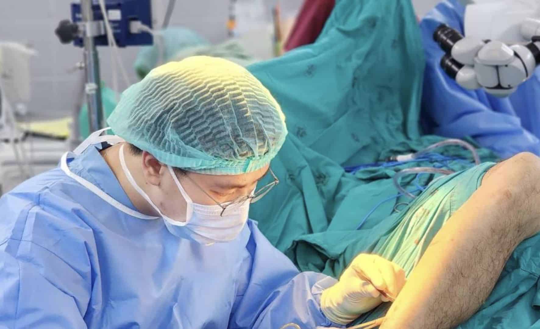 A surgeon performing on a patient