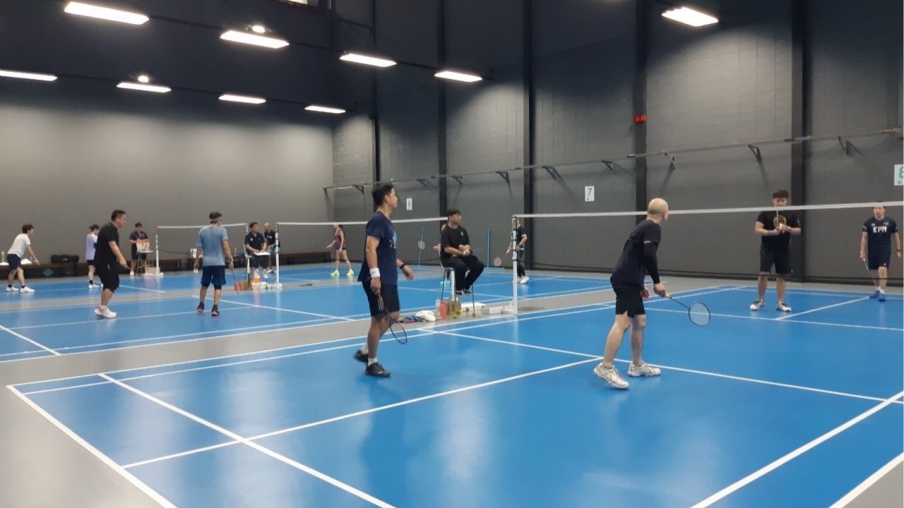 A badminton court at The Racquet Club in Bangkok, known for its professional facilities and vibrant community.