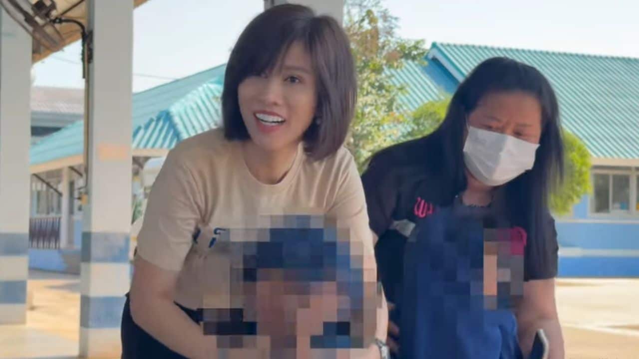 Chalida Palamat embraces two rescued siblings after child abuse case in Nakhon Phanom