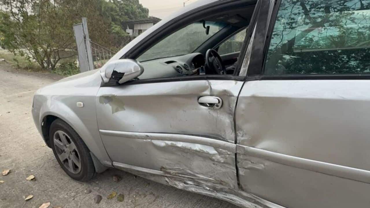 Damaged car and overturned motorcycle at Sai Noi crash scene