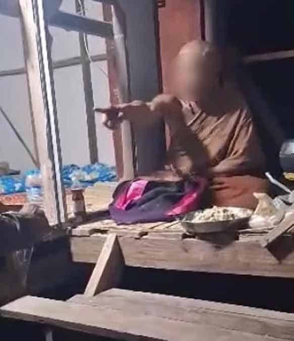 Monk pointing during forest temple disturbance in Udon Thani