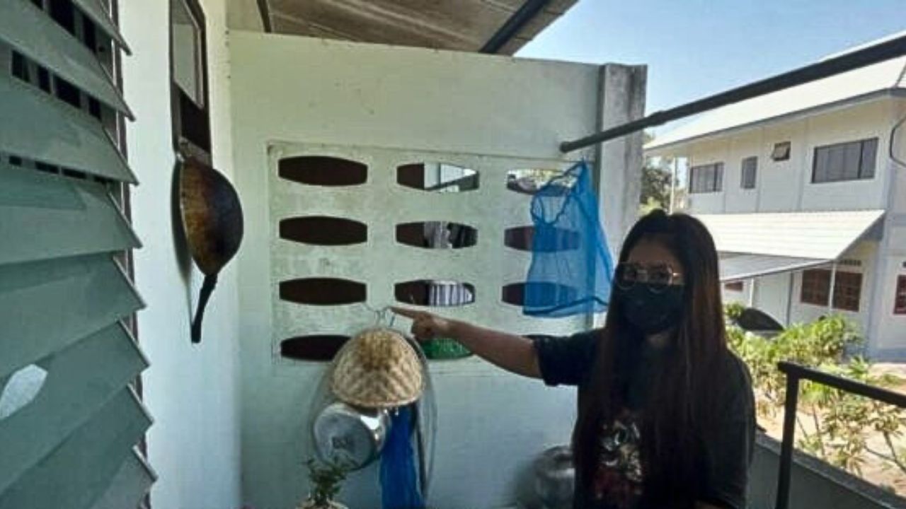 Chon Buri factory worker at kitchen area behind her dormitory room