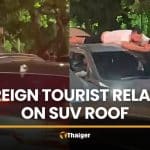 Foreigner seen relaxing on SUV roof during Phuket traffic | Thaiger