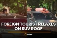Foreigner seen relaxing on SUV roof during Phuket traffic | Thaiger