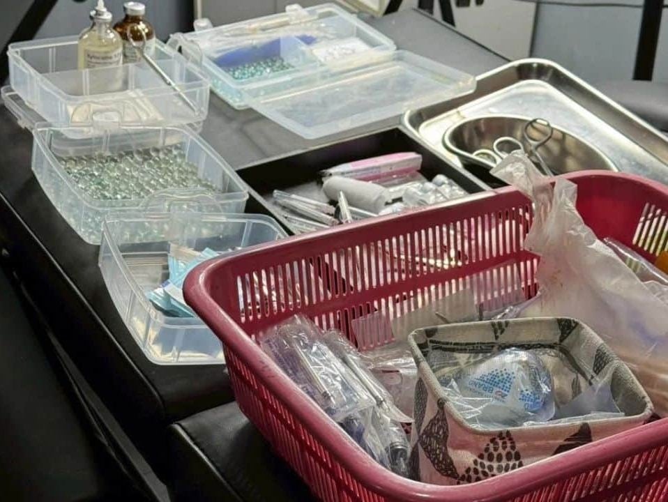 Seized medical equipment including pearl beads, filler injections and surgical blades from illegal clinic in Chon Buri