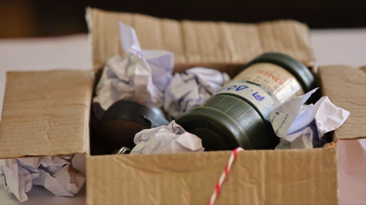 Police officers display seized M16 rifles and grenades during a raid in Nakhon Si Thammarat