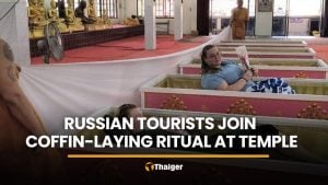 Russian tourists join coffin-laying ritual at Nakhon Nayok temple | Thaiger