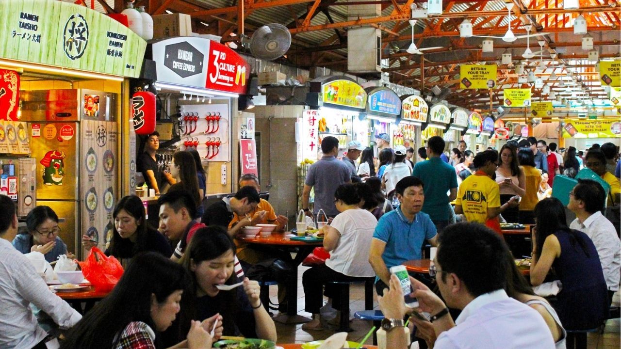 A bustling hawker centre in Singapore where chicken rice is a popular dish.