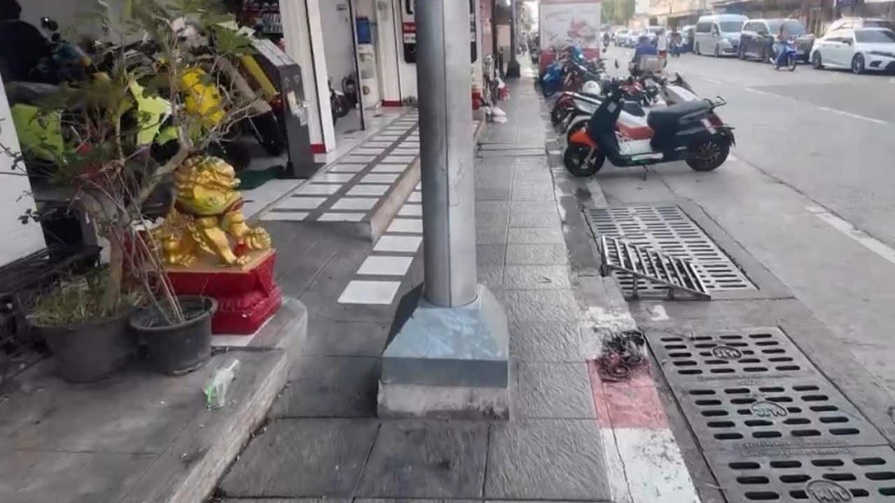 Foreign wheelchair user blocked by street light pole on footpath