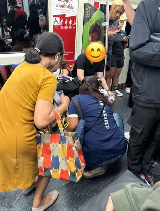 Thai women step in with tissues to help after coffee spills on a train