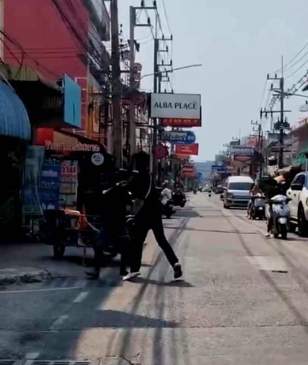 Two men trade punches after stopping a saleng in Chon Buri