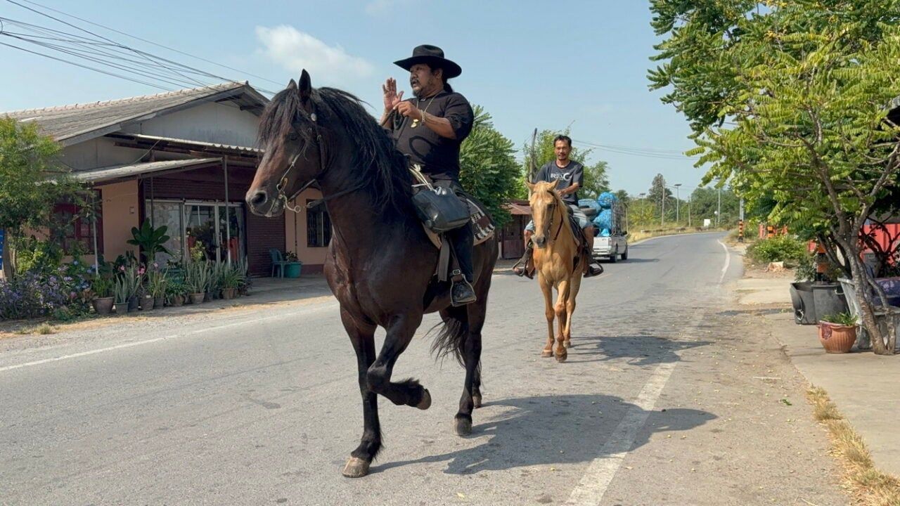 Ang Thong man rides horse through village in search of petrol