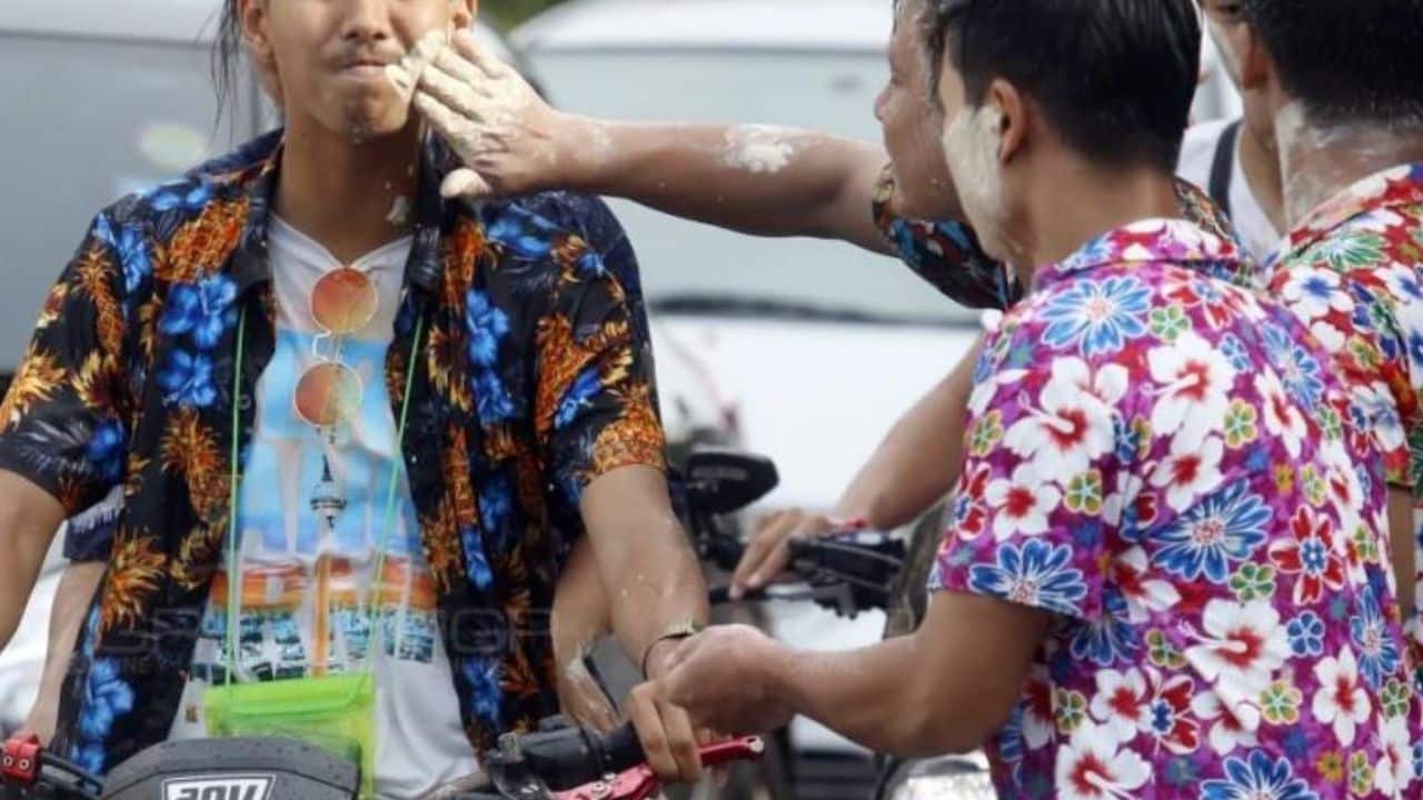 Applying powder on face during Songkran Festival