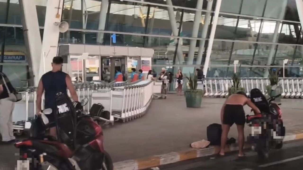 Foreign men left rental motorcycles outside Phuket airport terminal