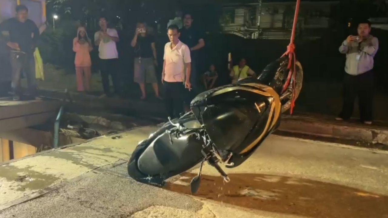 A motorcycle plunged into a construction pit in Nonthaburi, injuring two people before rescuers pulled an unconscious woman from below.