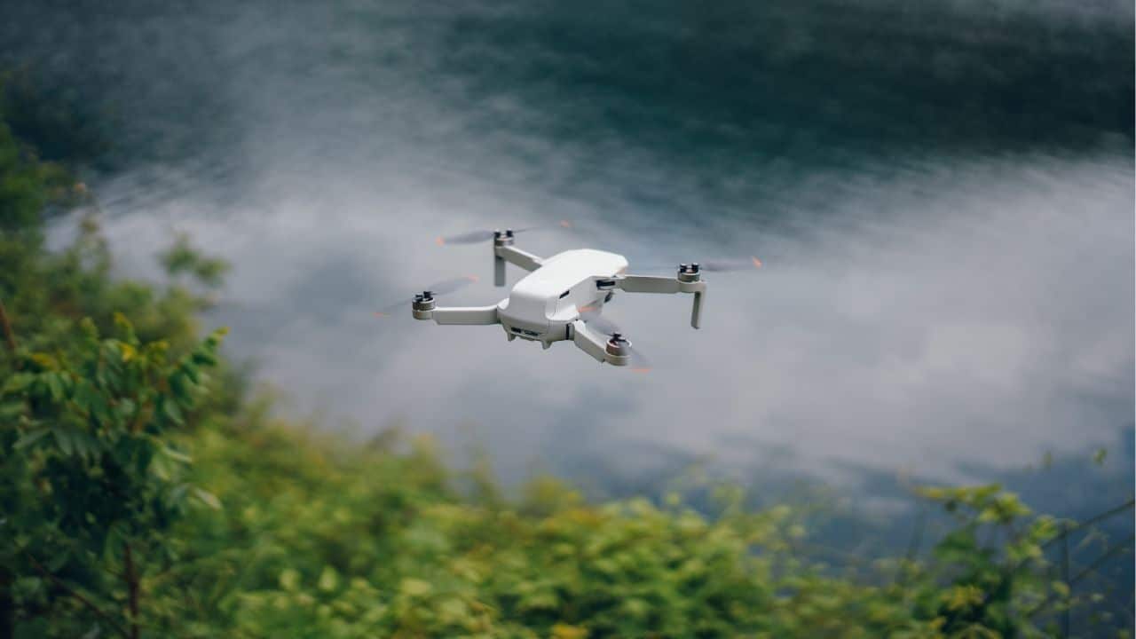 A drone flying over a scenic landscape in Thailand, highlighting the importance of understanding drone laws.