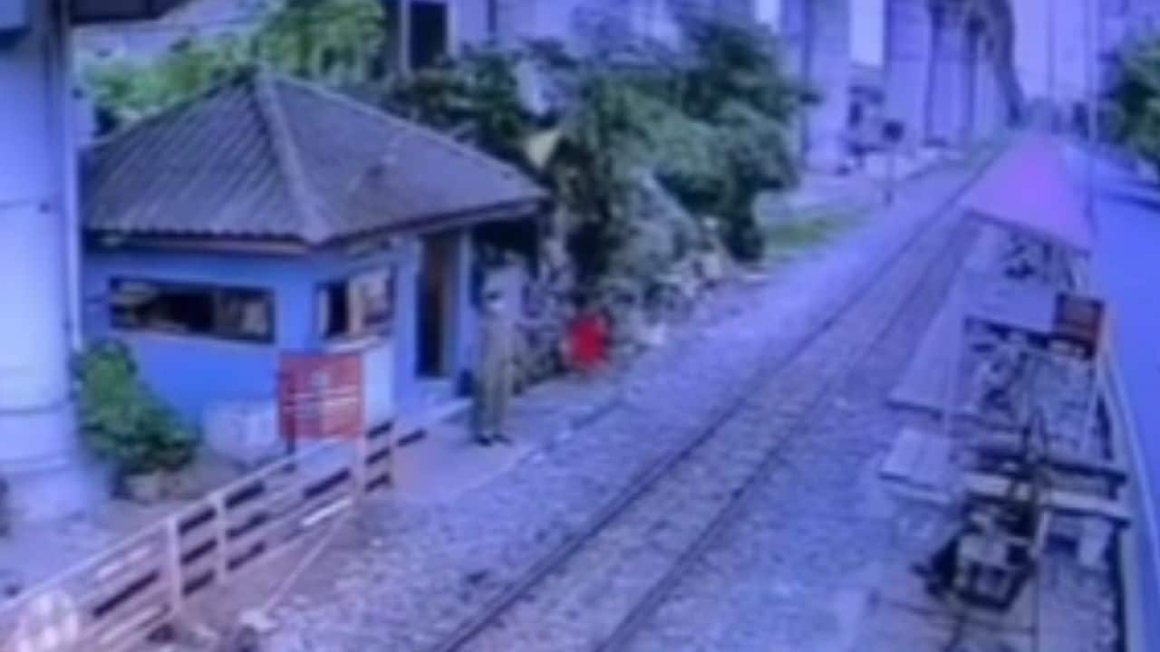 Station manager signal train driver with red flag