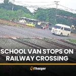 School van driver ignores barriers, stops on tracks as train approaches | Thaiger