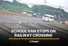School van driver ignores barriers, stops on tracks as train approaches | Thaiger