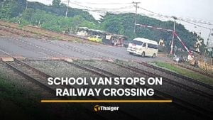 School van driver ignores barriers, stops on tracks as train approaches | Thaiger