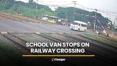 School van driver ignores barriers, stops on tracks as train approaches | Thaiger